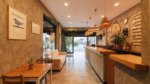 a restaurant with a bar with a couch and tables at Belci City House in Fethiye