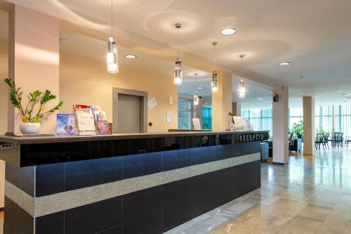 a lobby with a reception desk in a building at Hotel Fit Hévíz in Hévíz