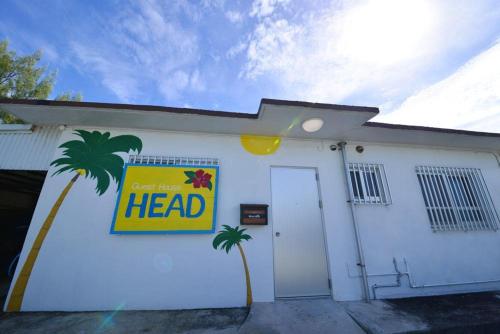 a white building with a heat sign on it at ペットＯＫ嘉手納基地に近い外人住宅Old America House -GuestHouseHead- in Kadena