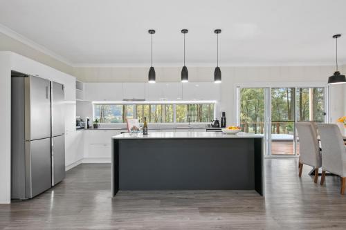 a kitchen with a large island in the middle at Little Corner Farm in Broke