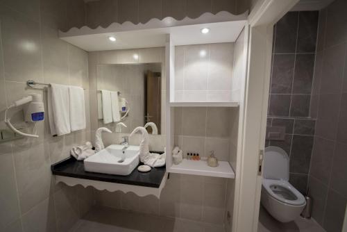 a bathroom with a sink and a toilet at Yeniceri City Hotel in Fethiye