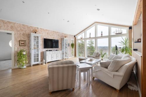 a living room with a couch and a table at Fantastisk Villa med extra allt in Tyresö