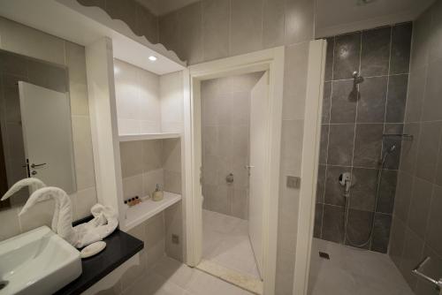 a bathroom with a shower and a sink at Yeniceri City Hotel in Fethiye