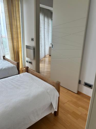 a bedroom with two beds and a mirror at Apartments Krug in Budva