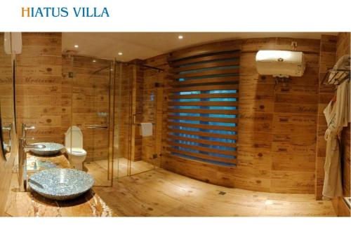 a bathroom with two sinks and a shower at H Resort Bohol - The Coral Cliff by SMS Hospitality in Calape