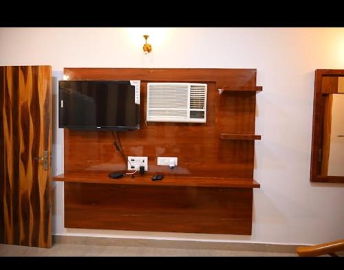 a flat screen tv on a wall in a room at The Crown Hotel in Murthal