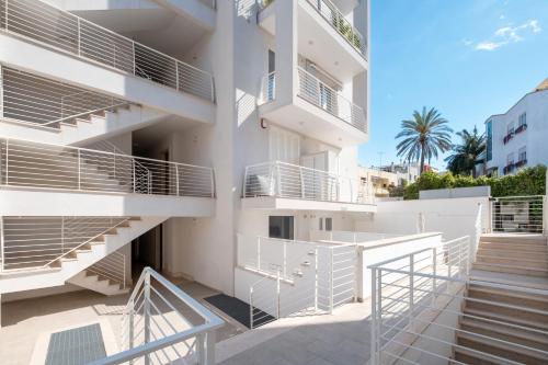 a building with white balconies and stairs on it at Dimora Idrusa in Otranto