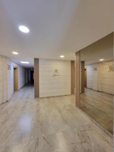 a large empty room with wooden walls and tile floors at Park Residence Apartman 1, Mirijevo, Beograd in Belgrade