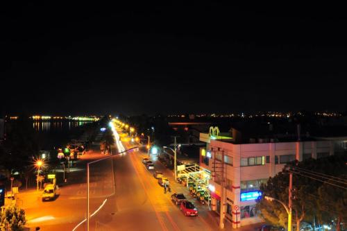 a city street at night with cars and street lights at Yeniceri City Hotel in Fethiye