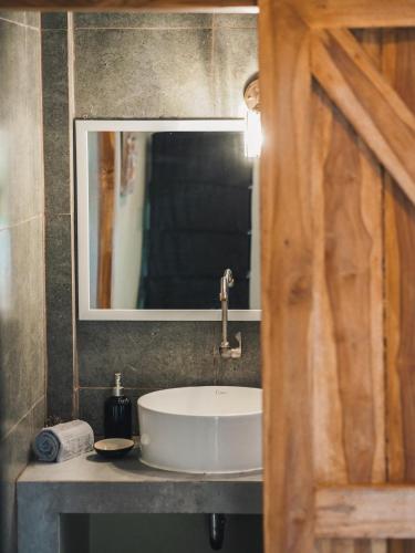 a bathroom with a sink and a mirror at Secret Spot Surf and Stay in Kuta Lombok