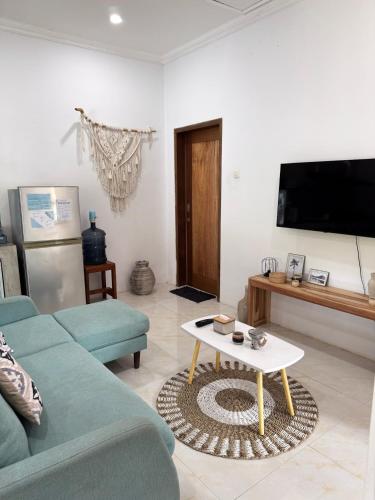 a living room with a couch and a coffee table at Secret Spot Surf and Stay in Kuta Lombok