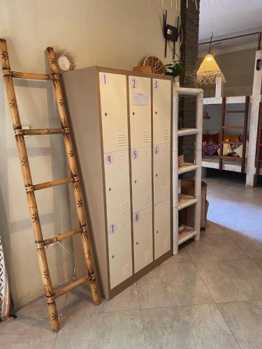a group of lockers in a room with a ladder at Secret Spot Surf and Stay in Kuta Lombok