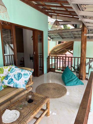 a living room with a couch and a table at Secret Spot Surf and Stay in Kuta Lombok