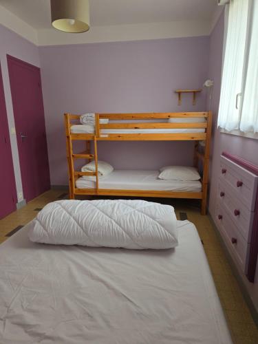 a bedroom with two bunk beds and a white bed at Maison Guy-Nadette in Saint-Georges-de-Didonne