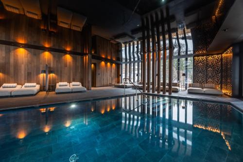 a swimming pool in a room with a large window at Hotel Vioz in Peio Fonti