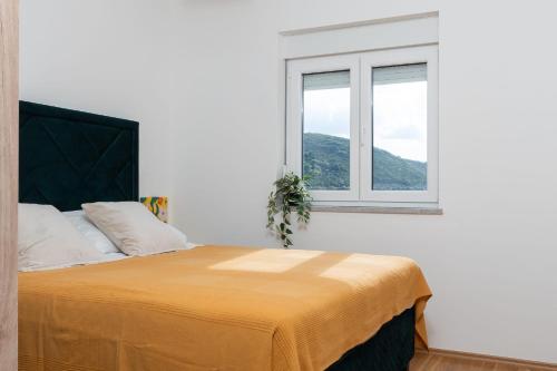 a bedroom with a large bed with a window at Mima in Neum