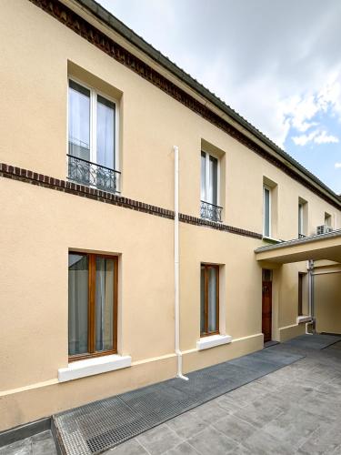a house with windows and a driveway at Villa Des Bégonias - PSG in Le Pré-Saint-Gervais