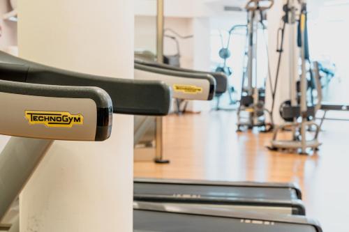 a row of exercise equipment in a gym at Mercure Olbia in Olbia