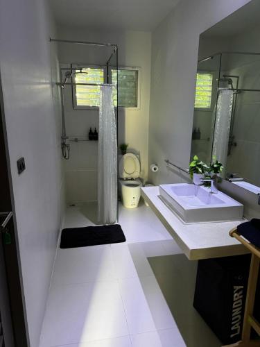 a bathroom with a sink and a toilet and a mirror at Bangrak Cozy Stay in Koh Samui 