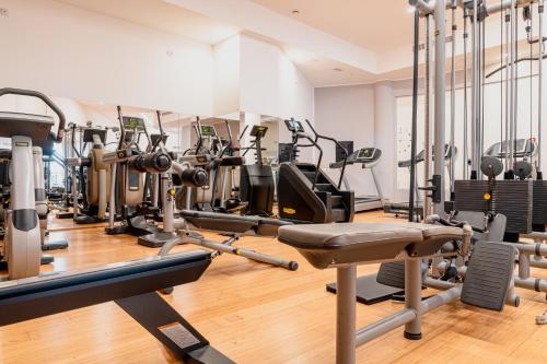 a gym with lots of treadmills and machines at Mercure Olbia in Olbia
