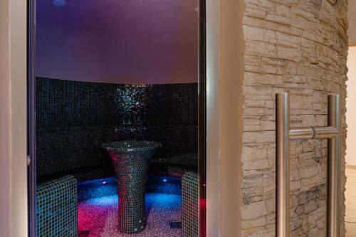 a shower with a glass door with a vase in it at Mercure Olbia in Olbia