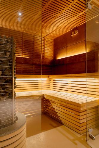 a room with a sauna with a glass wall at Mercure Olbia in Olbia
