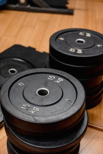 a stack of black disks sitting on a wooden floor at Mercure Olbia in Olbia