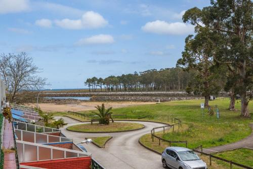 a car parked on a winding road near the beach at Luxury Coastal Apartment with Stunning Sea Views in Liñero