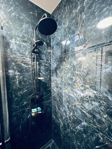 a bathroom with a shower with a glass wall at Comfortable one bedroom apartment in Świdnik