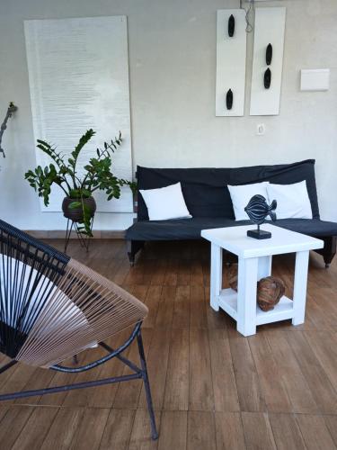 a living room with a couch and a table at Itamambuca Casa de Praia in Ubatuba