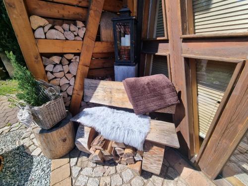 a wooden bench sitting next to a building at Landhaus Talblick- Frühstückspension in Brotterode-Trusetal