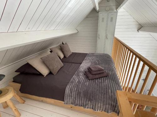 a bedroom with a bed in a attic at Studio Veerse Meer in Wolphaartsdijk