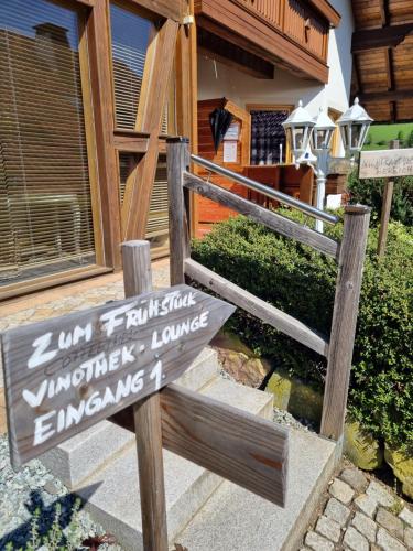 a sign in front of a house with a building at Landhaus Talblick- Frühstückspension in Brotterode-Trusetal