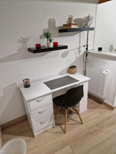 a white desk with a chair in a room at Spacious village house completely renovated in Pennautier