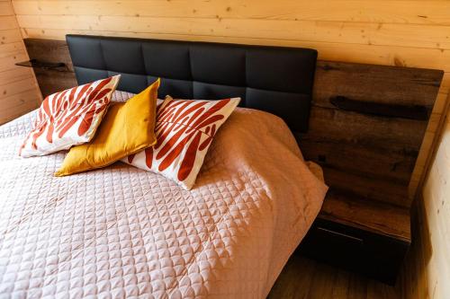 a bedroom with a bed with four pillows on it at Willa Aleksandria in Grabie