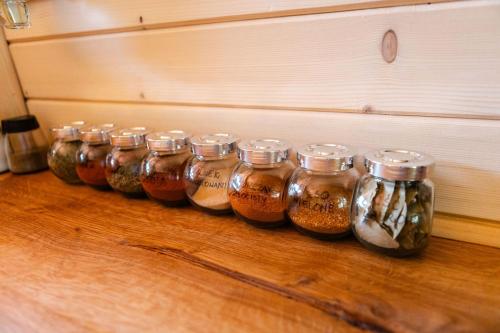 a row of jars filled with liquid on a wooden floor at Willa Aleksandria in Grabie