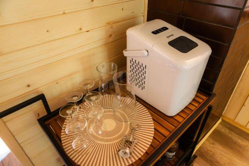 a small table with glasses and a machine on it at Willa Aleksandria in Grabie