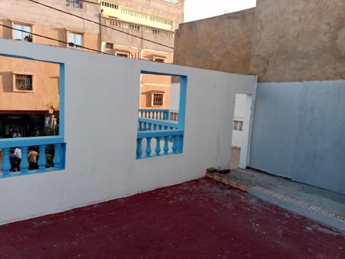 an empty room with two windows in a building at Atlantik Blick in Tamraght Ouzdar