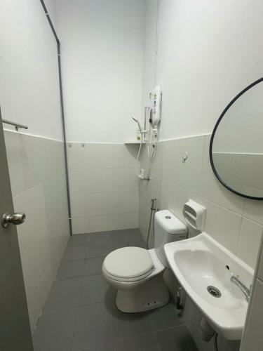 a bathroom with a shower and a toilet and a sink at Jalan Rambai 9 Family Suite 3 Bedroom in Pasir Gudang