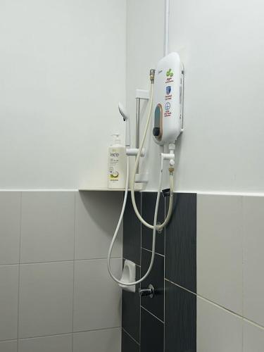 a bathroom with a hair dryer on the wall at Jalan Rambai 9 Family Suite 3 Bedroom in Pasir Gudang