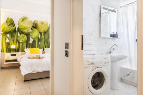 a bathroom with a bed and a washing machine at Forum City Apartments in Chania
