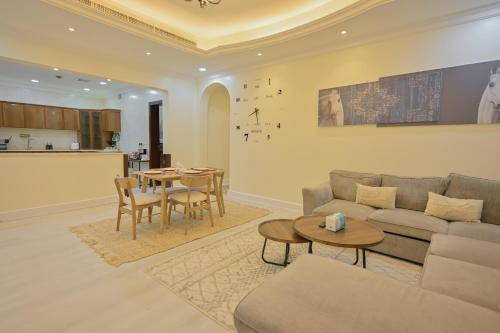 a living room with a couch and a table at RJ's - Beautiful 3 Bedroom Apartment in Al Khobar