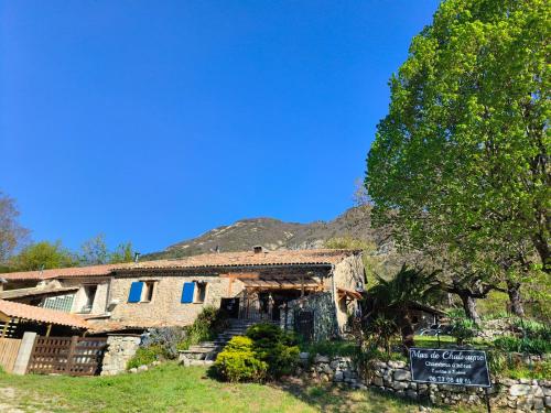 an old house with a sign in front of it at Mas de Chalvagne in Val-de-Chalvagne