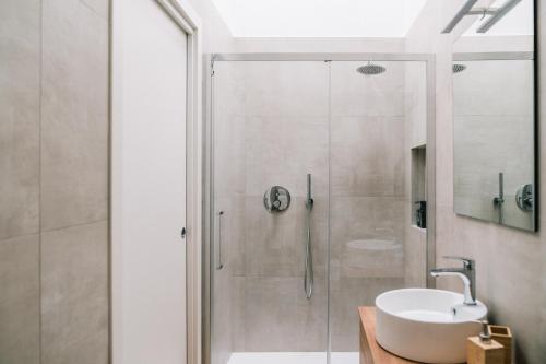 a bathroom with a shower and a white sink at La Bianca Dimora B&B in Gioia del Colle