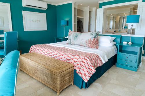 a bedroom with a bed with a blue wall at Last Word Long Beach in Kommetjie