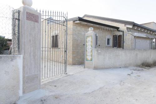 a gate in front of a brick building at Villa Adele Eleganza & Comfort in Pachino