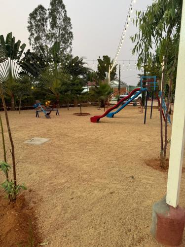 an empty playground with swings in a park at Farm life in Hyderabad