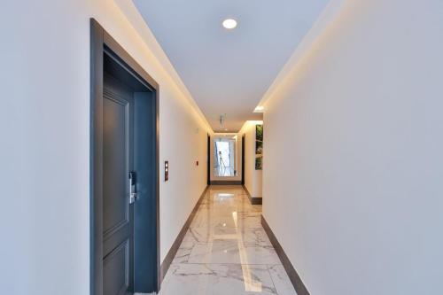 a hallway with a door and a tile floor at Brow City Kaş in Kas