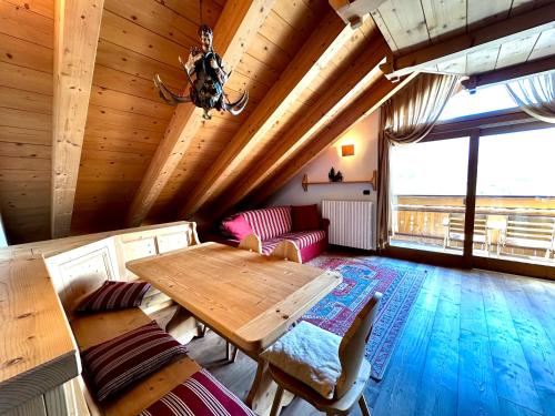 a living room with a wooden table and a couch at Alpine Escape 4 in Bormio