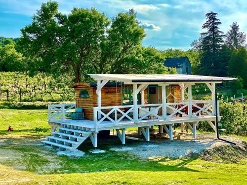 a tiny house with a porch and a roof at Tiny House at lake Balaton in Kisapáti